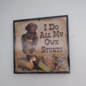 DOG THEME WALL PLAQUE.  "I DO ALL MY OWN STUNTS".  10 X 10 INCHES.  WILD WINGS.